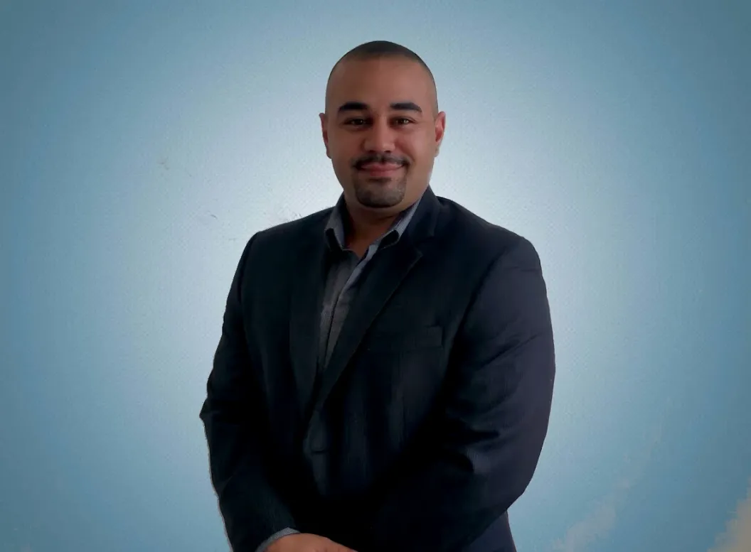 Professional portrait of Cristopher Cristia wearing a suit.